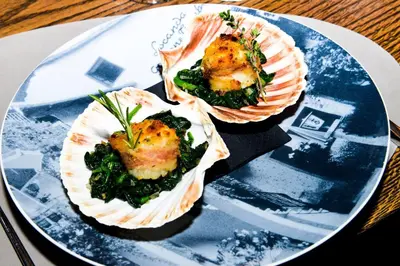 a blue plate with two wraps of food on it at Hotel Goldene Traube in Termeno