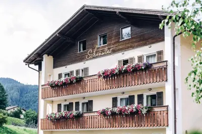 a building with flower boxes on it at Hotel Schönwies in Trodena