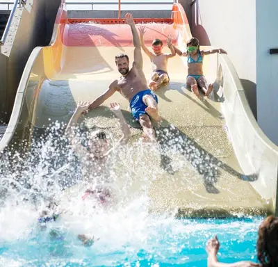 a group of people sliding down a water slide at Family Home Alpenhof in Maranza