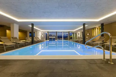 a large swimming pool in a hotel room at Family Home Alpenhof in Maranza
