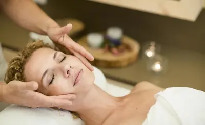 a woman getting a massage at a spa at Family Home Alpenhof in Maranza