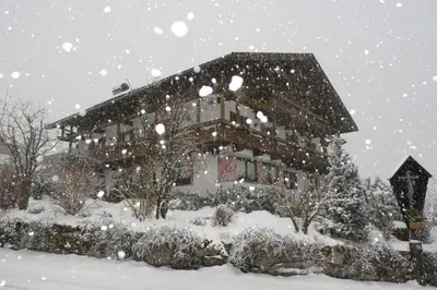 a house covered in snow in front at Residence Grünwald in Valles