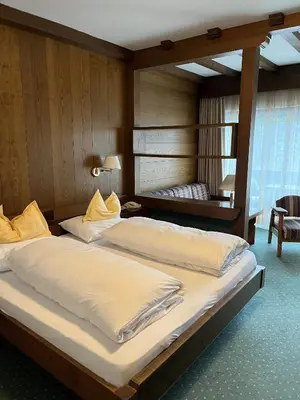 two large beds in a room with at Hotel Am Wolfgrubenersee in Soprabolzano