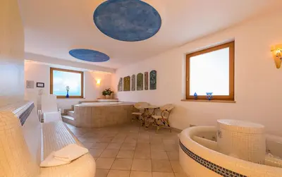 a wellness room with two jacuzzis at Hotel Alpenfrieden in Maranza