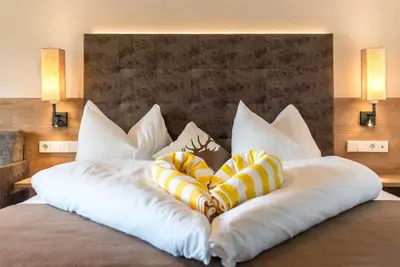 two pillows on a bed in a hotel room at Hotel Alpenfrieden in Maranza
