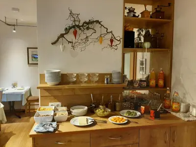 a kitchen with a table with food on it at Gasthof Anny in Marlengo