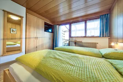 a bedroom with two beds and a window at Gasthof Anny in Marlengo