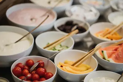 a bunch of bowls of food with chop sticks in them at Thalguter - Rooms & Breakfast in Lagundo