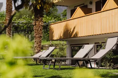 a group of benches in front of a house at Thalguter - Rooms & Breakfast in Lagundo