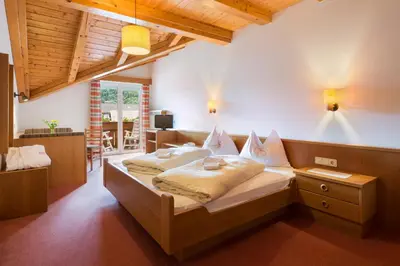a bedroom with a large bed in a room at Hotel Klotz in San Leonardo in Passiria
