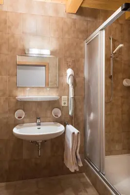 a bathroom with a sink and a shower at Hotel Klotz in San Leonardo in Passiria