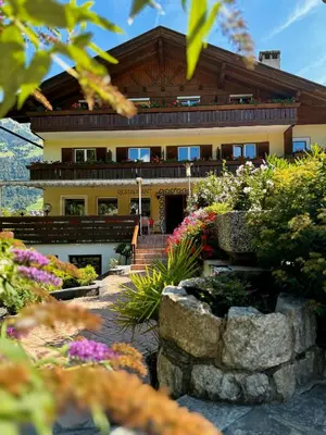 a building with a bunch of flowers in front of it at Hotel Klotz in San Leonardo in Passiria