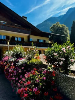 a row of flowers in front of a building at Hotel Klotz in San Leonardo in Passiria
