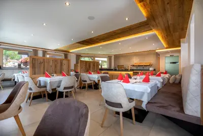 a dining room with white tables and chairs at Hotel Kronhof in Moso