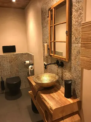a bathroom with a wooden sink and a toilet at Residence Rautal B&B ***S in San Vigilio Di Marebbe