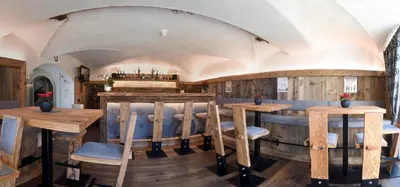 a dining room with wooden tables and chairs at Residence Rautal B&B ***S in San Vigilio Di Marebbe