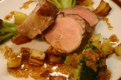 a plate of food with meat potatoes and broccoli at Panoramapension Etschblick in Meltina