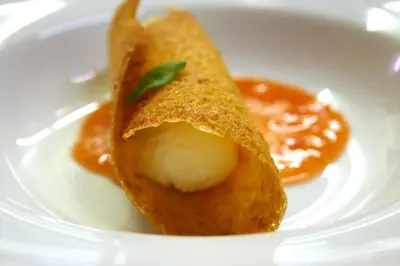 a piece of food on a white plate with sauce at Panoramapension Etschblick in Meltina
