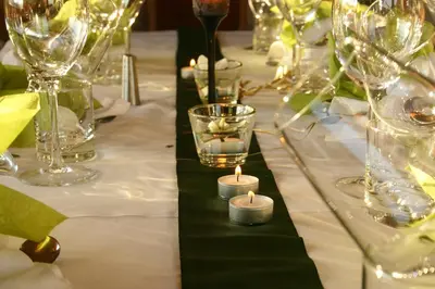 a table with wine glasses and candles on it at Panoramapension Etschblick in Meltina