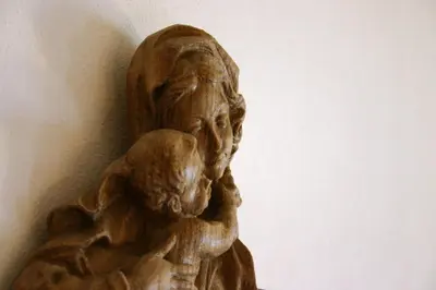 a statue of a woman holding a child at Panoramapension Etschblick in Meltina