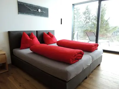 a couch with red pillows on it in a room at Residence Moritz in Avelengo