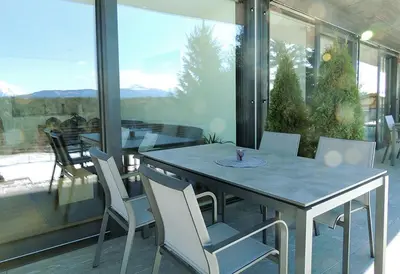 a table and chairs on a balcony with a view at Residence Moritz in Avelengo