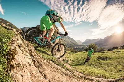 a man riding a mountain bike on a hill at Hotel Traminerhof in Termeno
