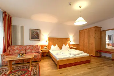 a living room with a bed and a couch at Steinegger Eppan in Appiano sulla Strada del Vino