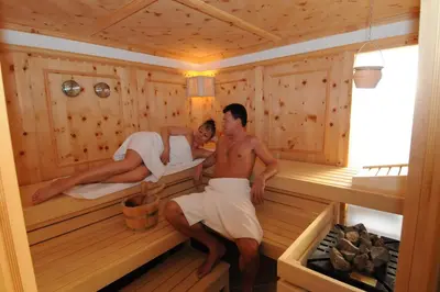two people are sitting in a sauna at Steinegger Eppan in Appiano sulla Strada del Vino