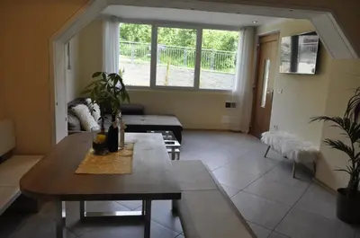 a living room with a table and a large window at Ferienwohnungen Niederhof in Lana