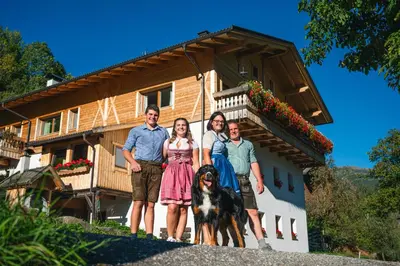 a group of people standing in front of a house at Schweinsteghof Urlaub auf dem Bauernhof in Sarntal