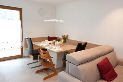 a living room with a table and a couch at Schweinsteghof Urlaub auf dem Bauernhof in Sarntal