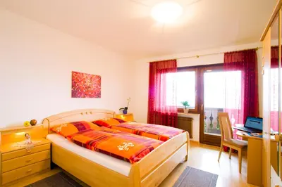 a bedroom with a bed and a desk and a window at Appartements Peilerhof in Cermes