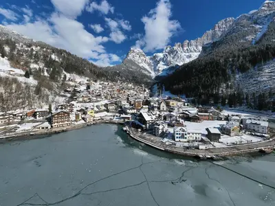 an aerial view of a town with snow covered mountains at Europa Mountain Apartments in Alleghe