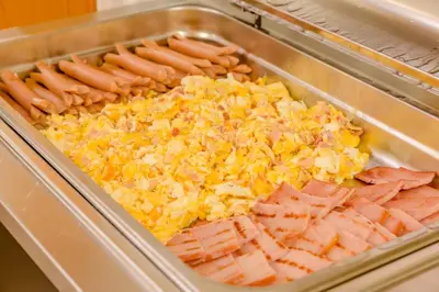 a tray filled with hot dogs and sausages at Albergo Genzianella in Rocca Pietore
