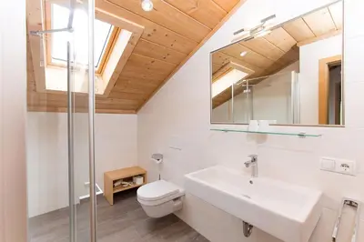 a bathroom with a sink and a toilet and a mirror at Appartement Riederhof in Saltusio