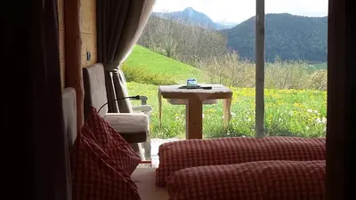 a table and chairs in a room with a view of a field at Albergo Gasthof zur Krone in Laion