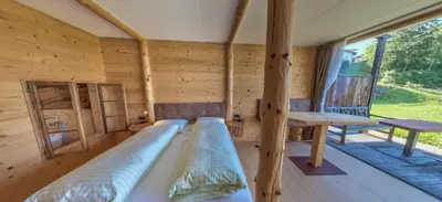 a room with two beds in a log cabin at Albergo Gasthof zur Krone in Laion