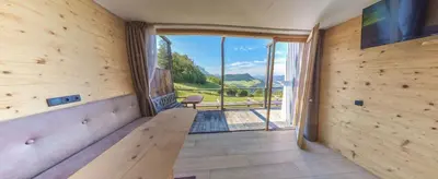 a wooden room with a bench and a large window at Albergo Gasthof zur Krone in Laion