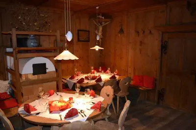 a dining room with tables and chairs in a cabin at Albergo Gasthof zur Krone in Laion