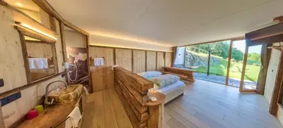 a large room with a bed and a large window at Albergo Gasthof zur Krone in Laion