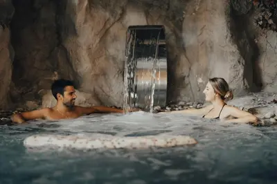a man and a woman in a hot tub at Hotel La Soldanella in Moena