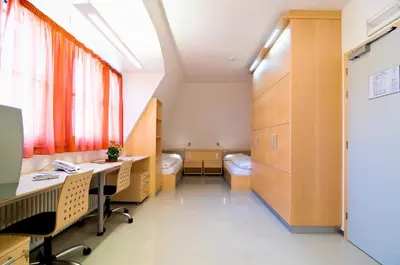 an office with desks and chairs in a room at Kolpinghaus Bolzano in Bolzano