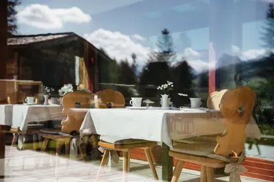 a group of tables and chairs in a restaurant at Garni Ciasa Urban in Badia