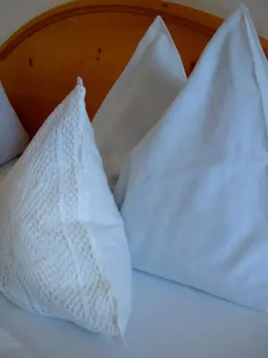 a wall of white towels in a restaurant at Hotel Tyrol in Funes
