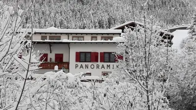 a building with the words panoramic is covered in snow at Garni Panoramik in Ortisei