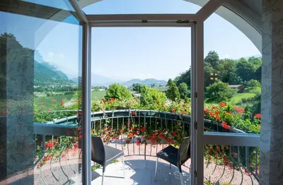 a view from a window of a balcony with flowers at Gartenhof in Bressanone