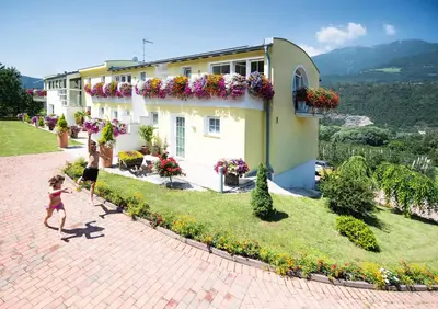 a building with a bunch of flowers on it at Gartenhof in Bressanone