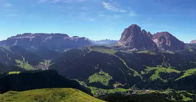 a view of a mountain range with trees and houses at Villa Insam Apartment in Selva di Val Gardena