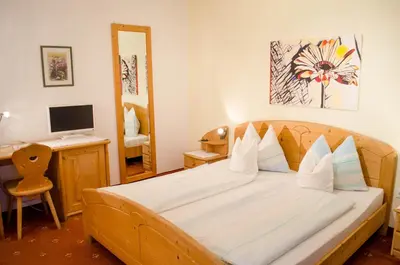 a bedroom with a bed and a desk with a computer at Garni Meinrad in Ora/Auer